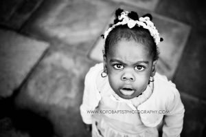 Little girl looking up at the camera.