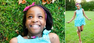 Young girl lying down on green grass