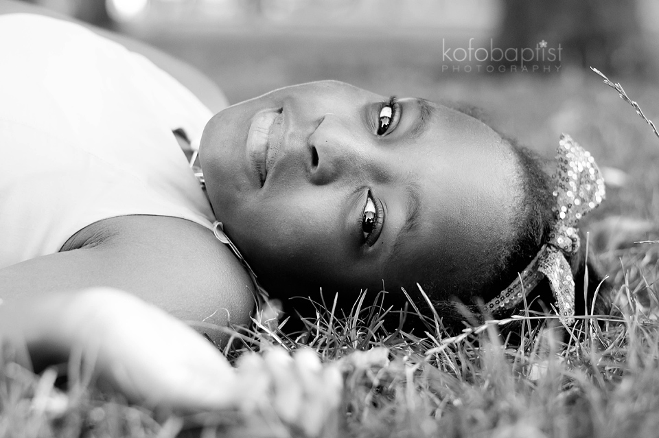 Young girl lying down on grass