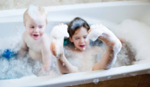 Young brother and sister having a bubble bath