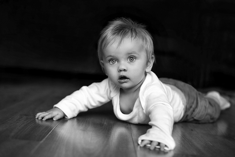 Baby lying door on the wooden floor