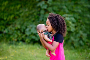Little girl kissing doll