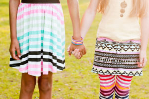Holding hands black and white children