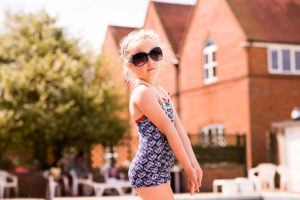 Little girl in swimsuit at pool