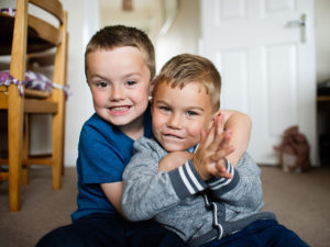 Big brother with little brother photographed by London child photographer Kofo Baptist.
