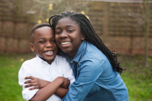 Portrait of brother and sister hugging captured by London child photographer Kofo Baptist.