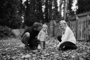 Black and white photo of mum, dad and toddler son