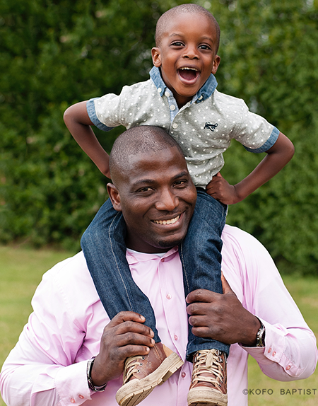 Son on daddy's shoulder. 