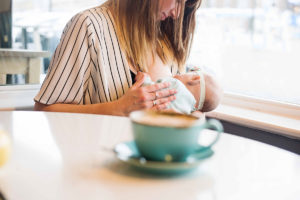 Breastfeeding photography: a mother nurses a baby
