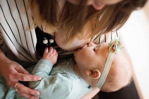 Breastfeeding photography: a mother nurses a baby