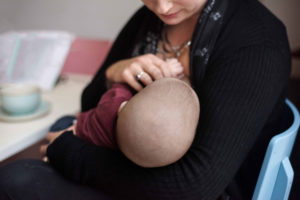 Breastfeeding photography: a mother nurses a baby