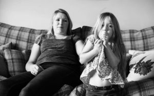 Little girl and her mum in living room