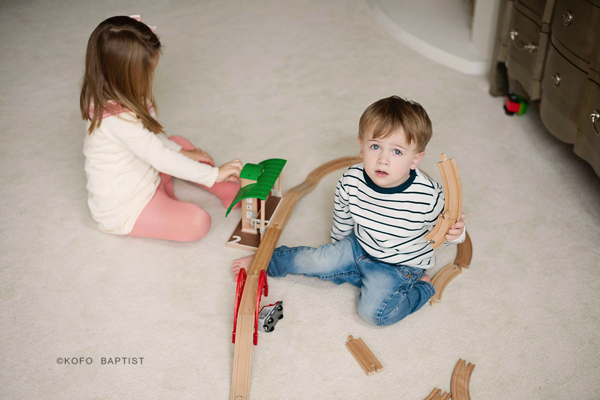Brother and sister playing with toys
