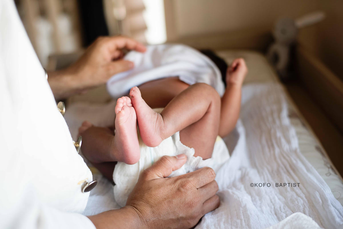 Mum lifting baby up from changing mat
