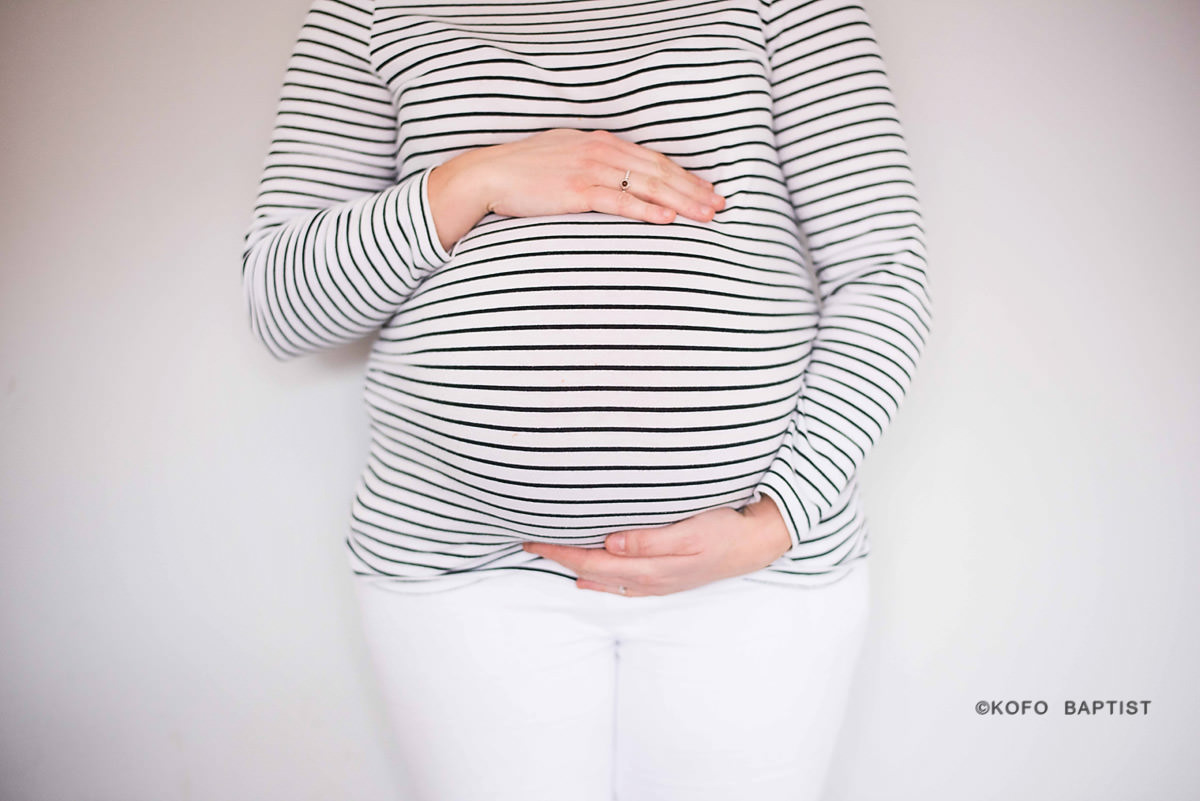 Pregnant mum holds baby bump
