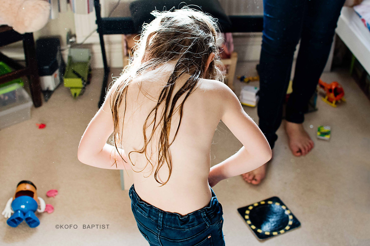 Young girl getting changed.