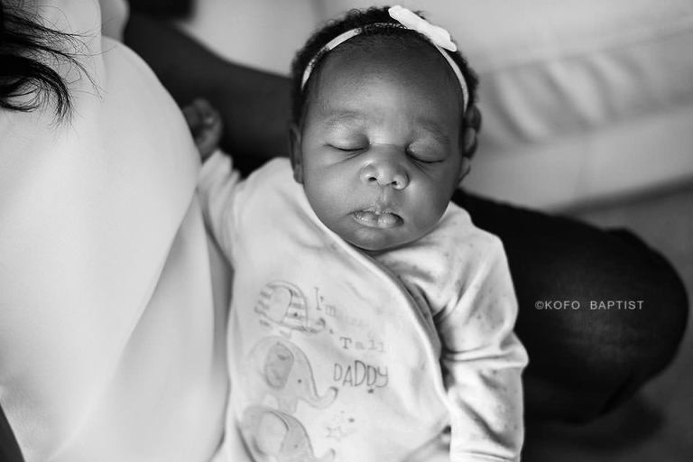Mother holding newborn baby in her arms. 