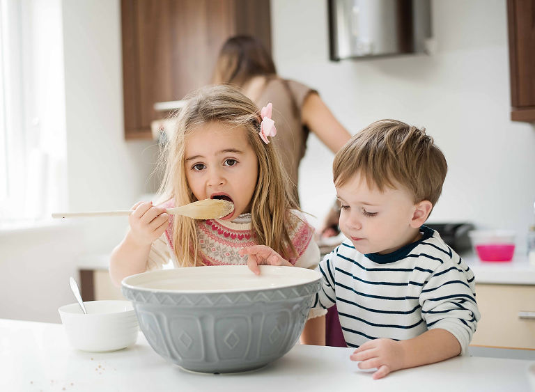 Brother and sister baking cookies.