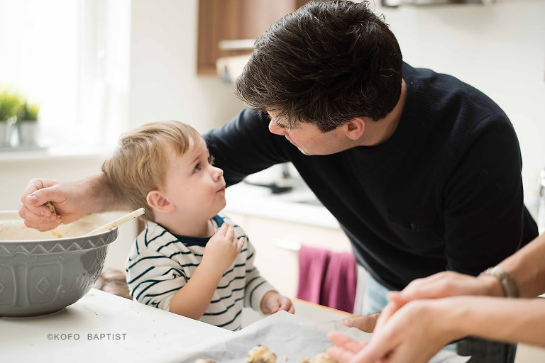 Toddler boy looking up at dad