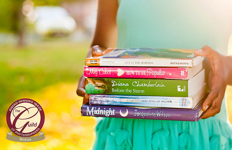 Girl with hand under chin.