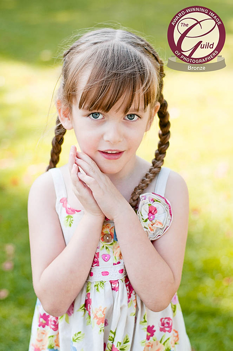 Teen girl carrying a pile of books.