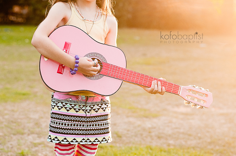 Young girl playing guitar by Colchester Essex Child Photographer Kofo Baptist
