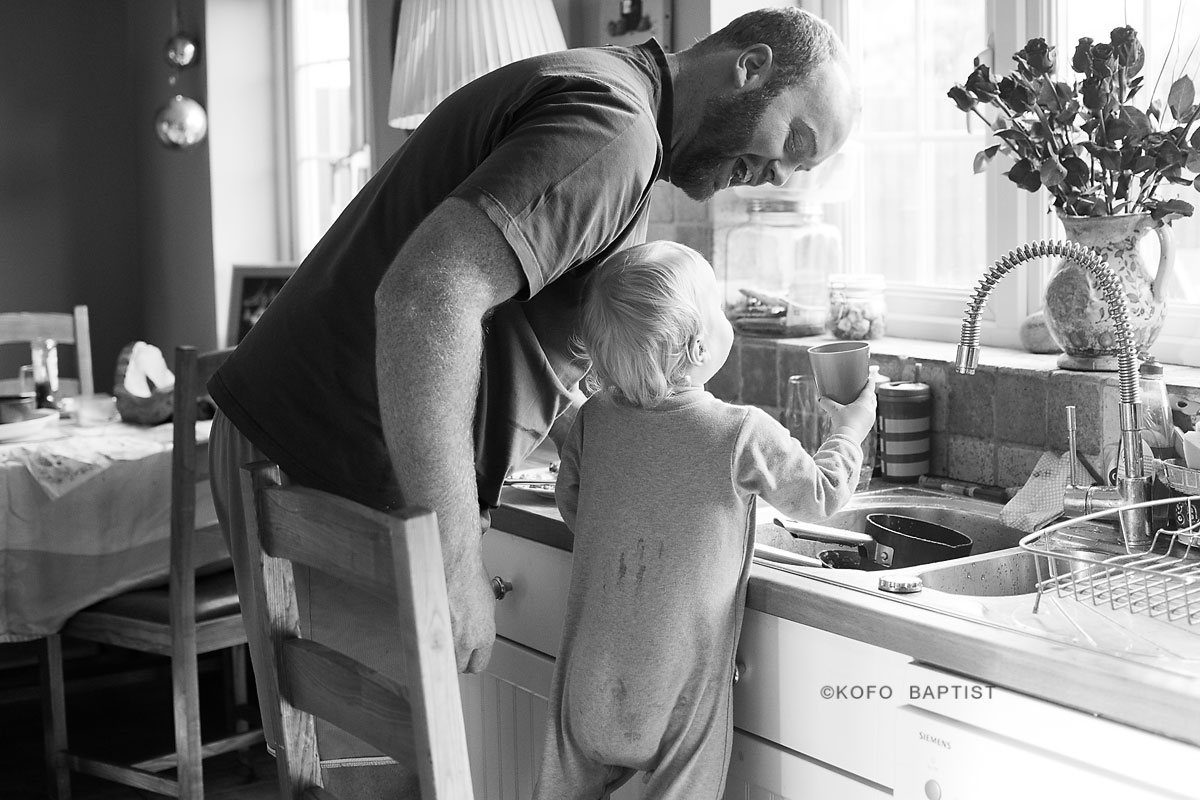 London child photographer photographs toddler and his dad in the kitchen.