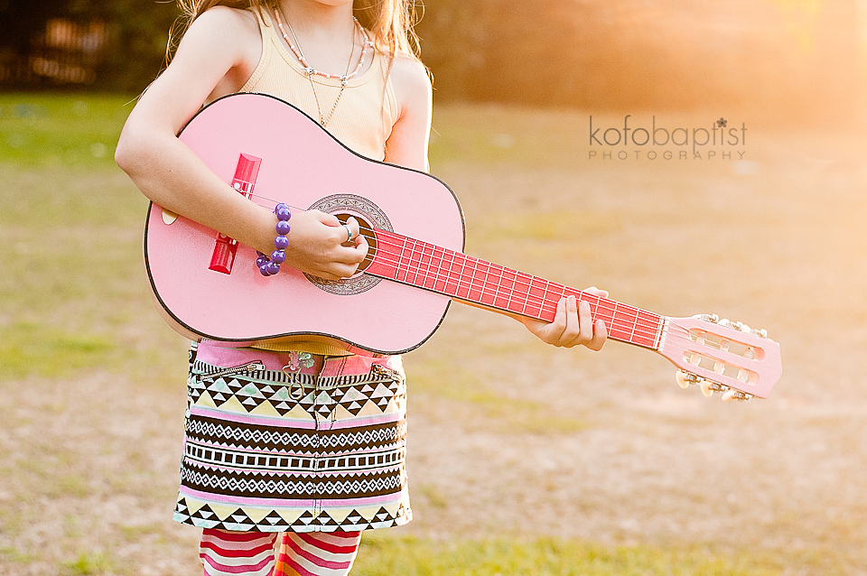 Young girl playing guitar by Colchester Essex Child Photographer Kofo Baptist